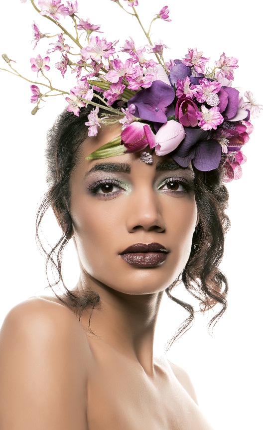 Portrait of model with green and purple eyeshadow wearing a purple flower crown. Makeup by Top Notch Art of Makeup.