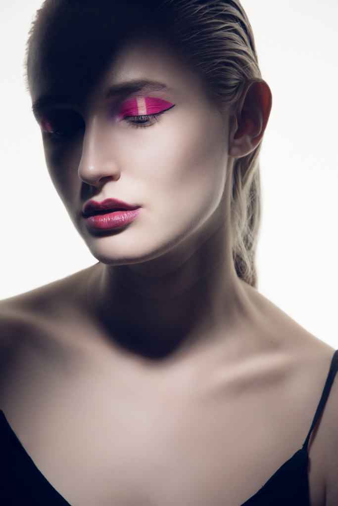 Creative pink asymmetrical eye makeup on model with pink lips. Makeup by Top Notch Art of Makeup